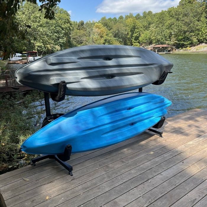 Kayaks stored lakeside, ready to paddle