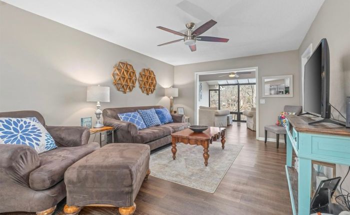 Open living room flowing into the upper sunroom