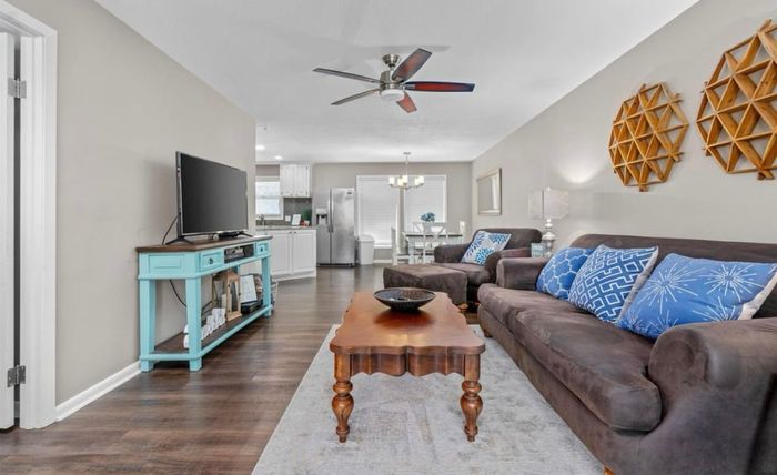 Open-concept living and dining with hardwood-look floors