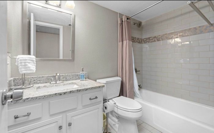 Full bathroom with vanity and tub
