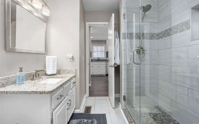 Bathroom with walk-in tile shower and vanity