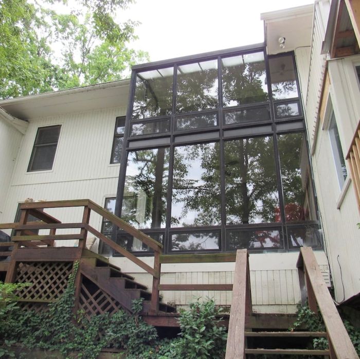 Rear of the home with sunrooms and decks