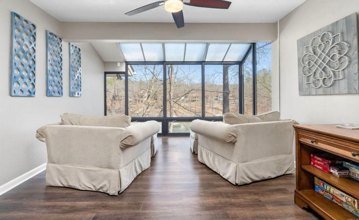 Glass sunroom with wraparound windows and lake views
